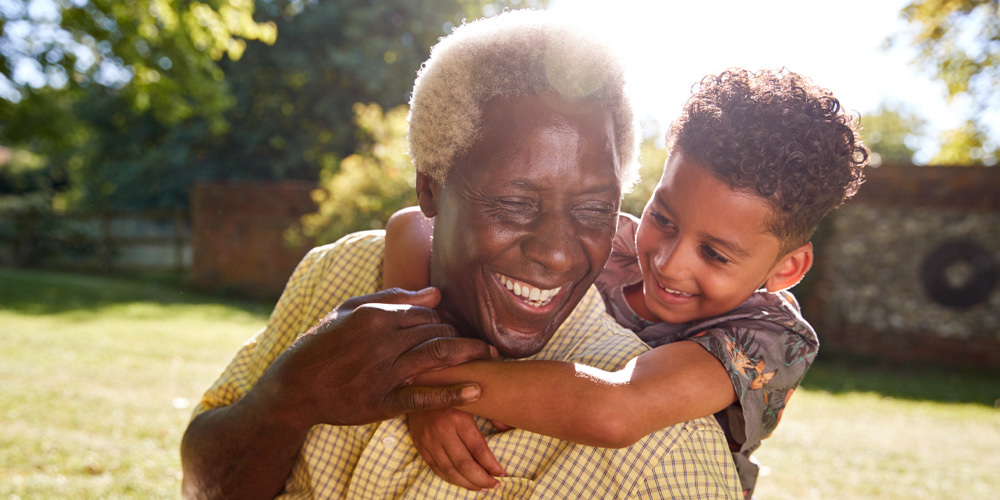 Grandfather and young boy smiling in the outdoors