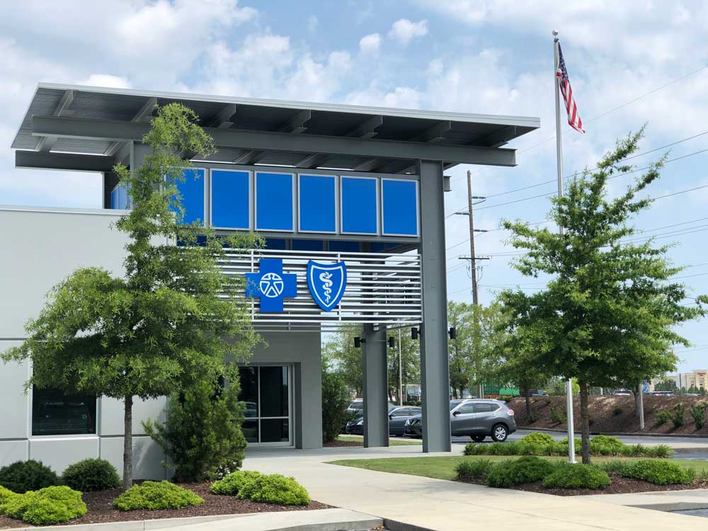 front of building with blue cross logo and blue sky